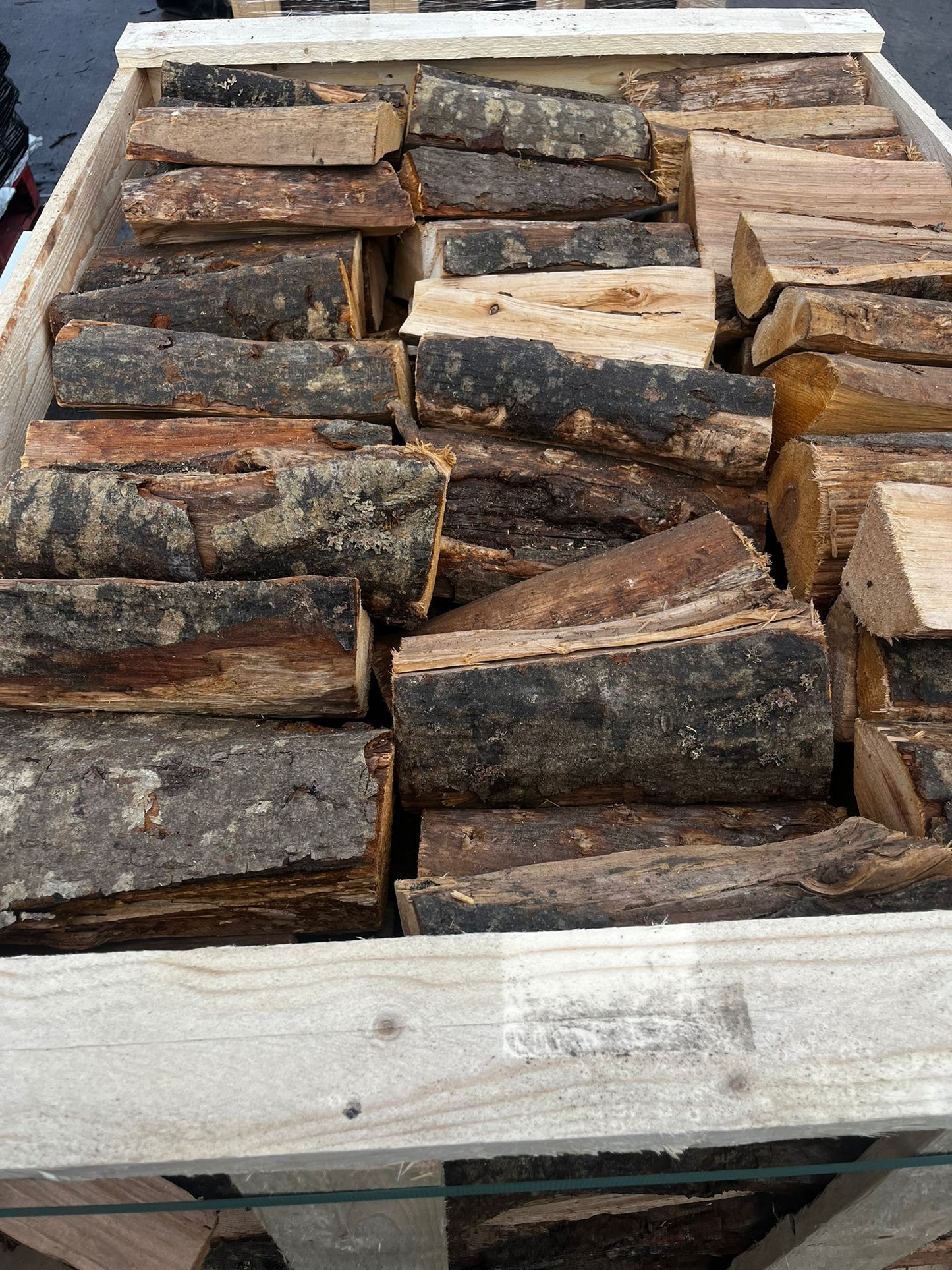 Stack of Alder firewood logs in a wooden crate Murphys Direct UK