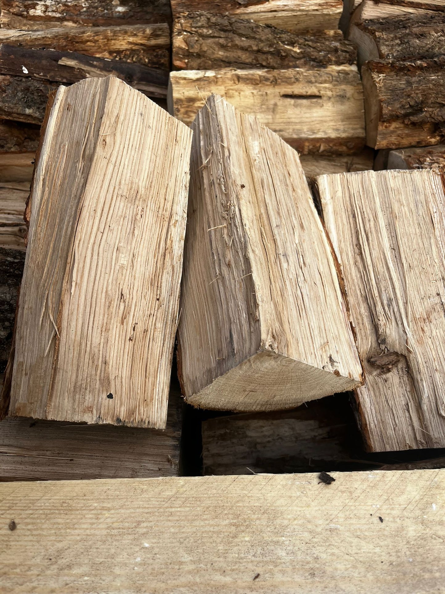 Stack of Oak wooden logs with visible grain and texture Murphys Direct UK