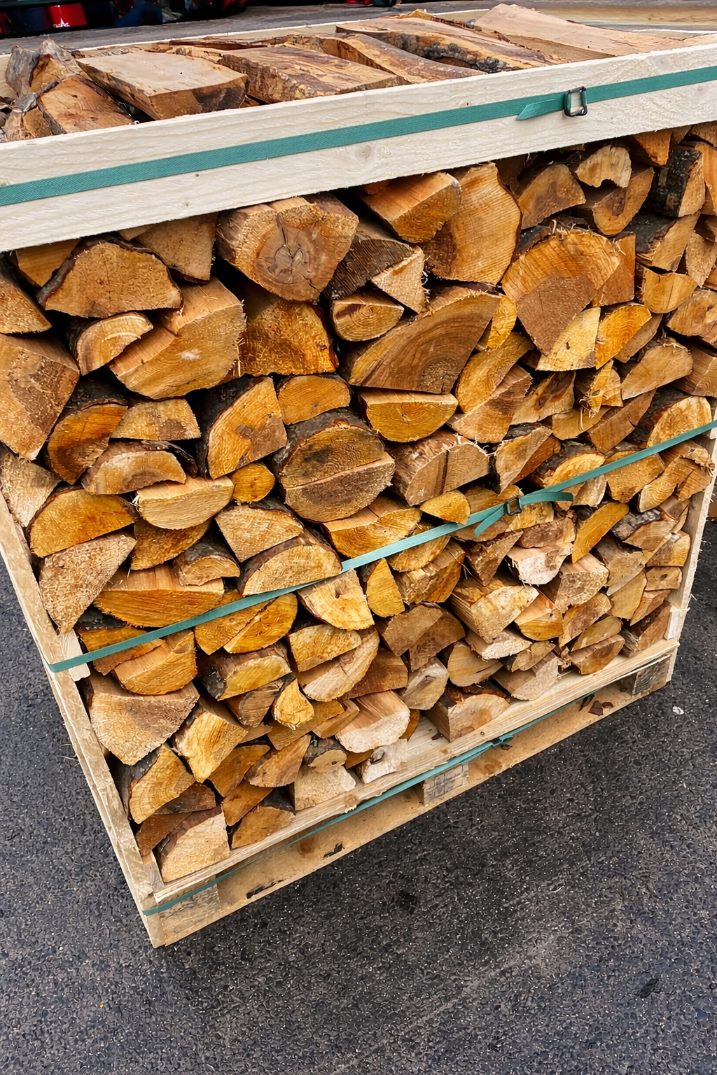 Stack of Alder firewood in a wooden crate on a concrete surface Murphys Direct UK
