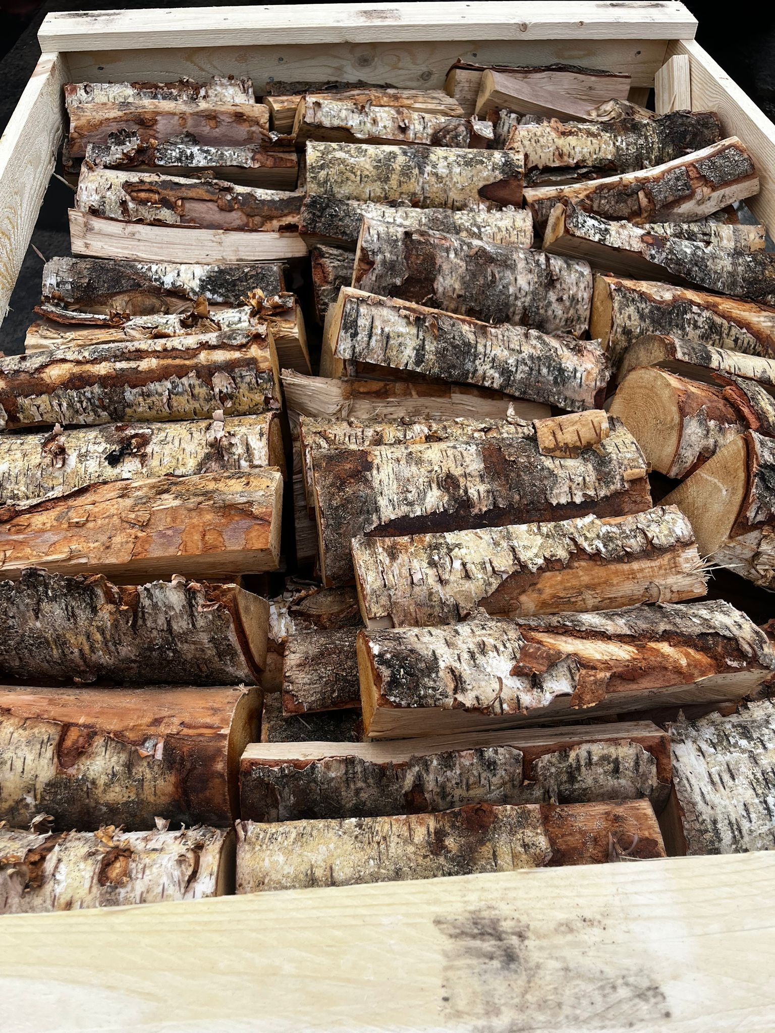 Stack of Birch firewood logs in a wooden box Murphys Direct UK