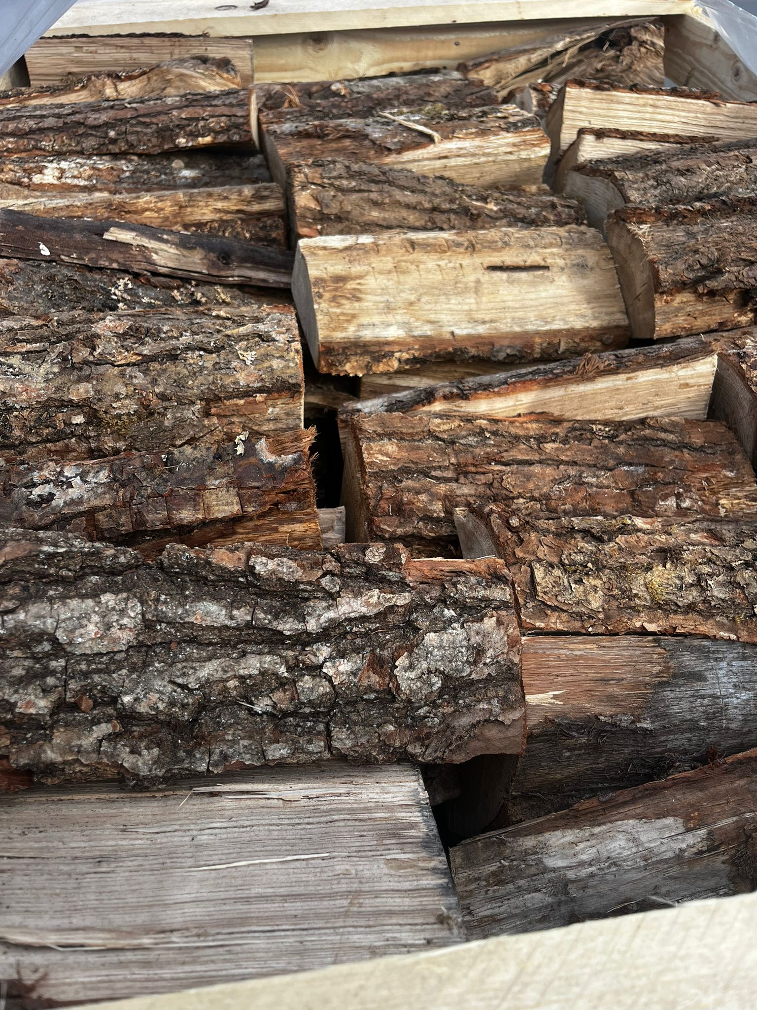 Stack of chopped Oak logs with a natural brown color. Murphys Direct UK