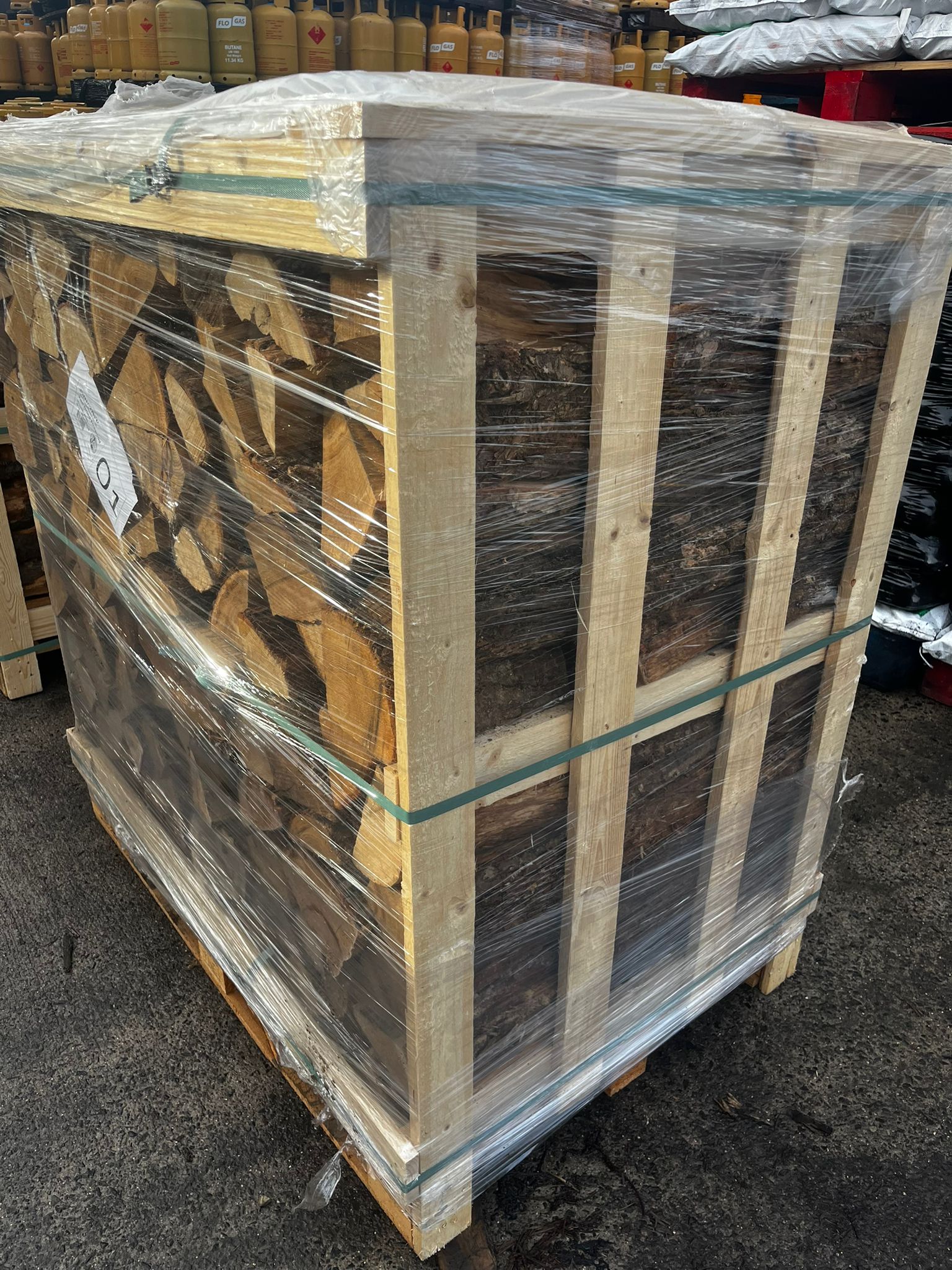 Stack of Oak wooden Crates wrapped in plastic on a concrete floor. Murphys Direct UK